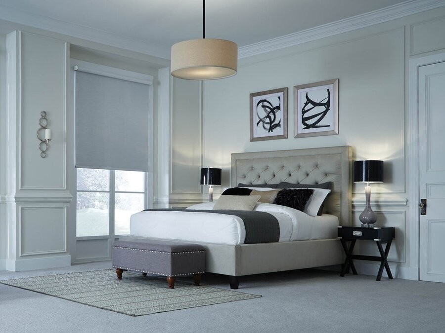 A bedroom illuminated by a proper lighting design featuring Lutron lighting fixtures.